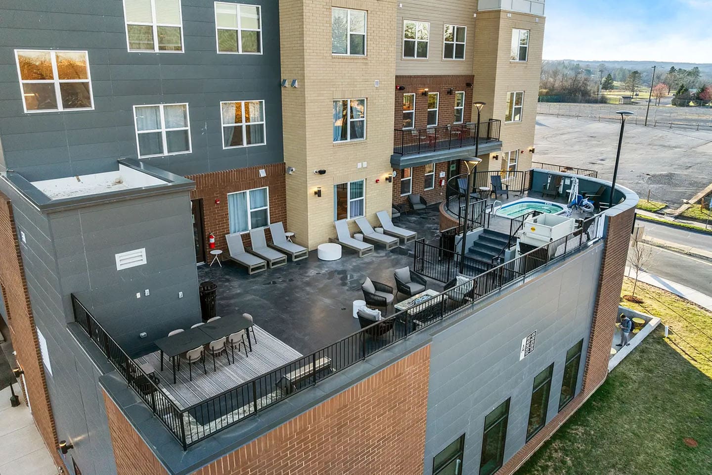 rooftop hot tub with lounge chairs and seating areas.