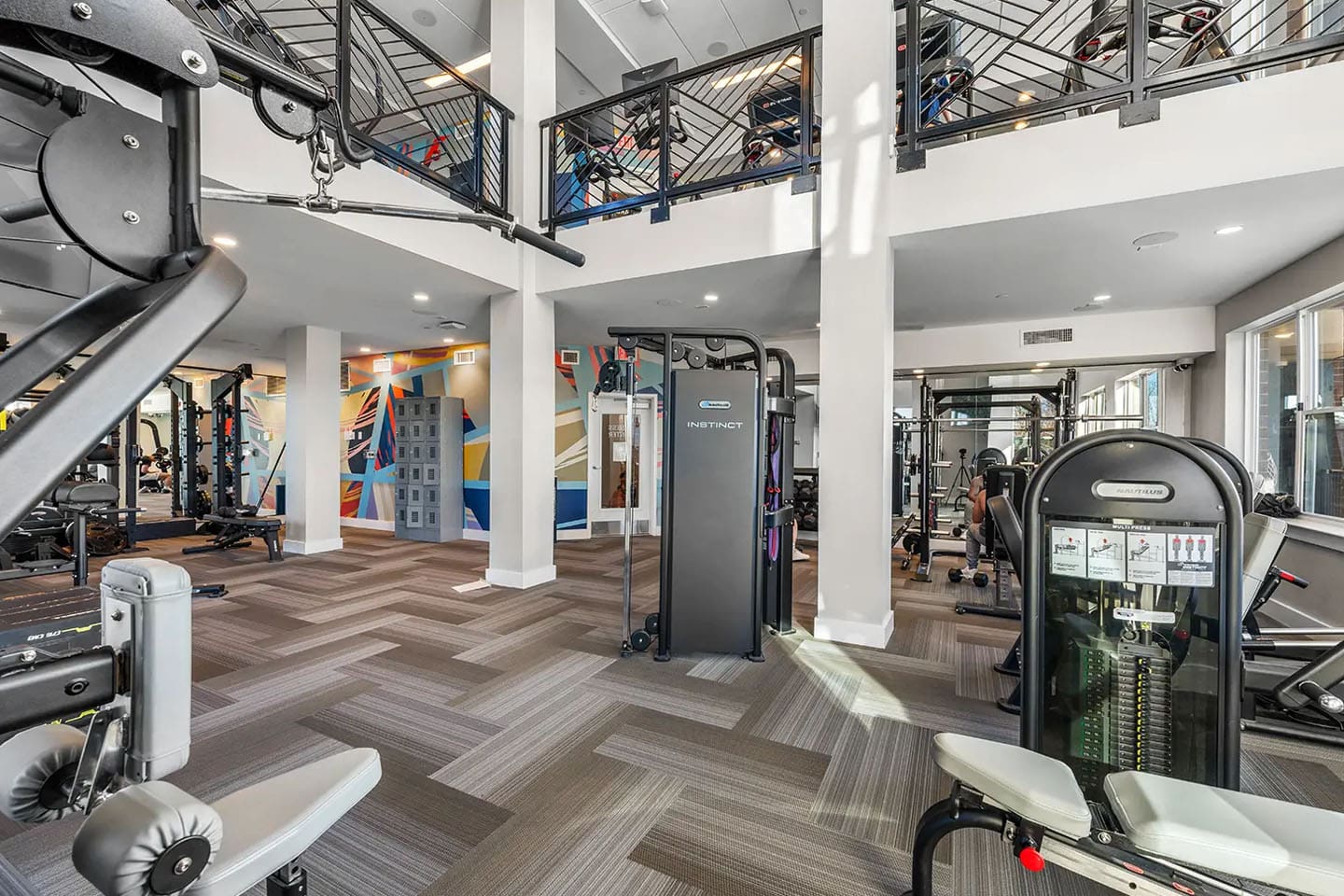 Two story fitness center with a variety of weight equipment.