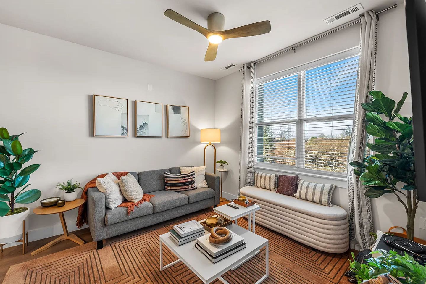 Fully furnished living room with a large window.